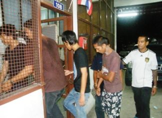 Some of the many suspects caught at the polls are led into the station for processing.